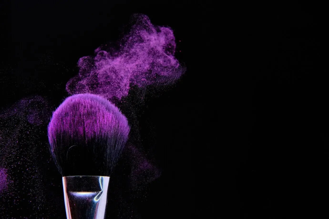 A beautiful photo of a makeup brush set against a black background.