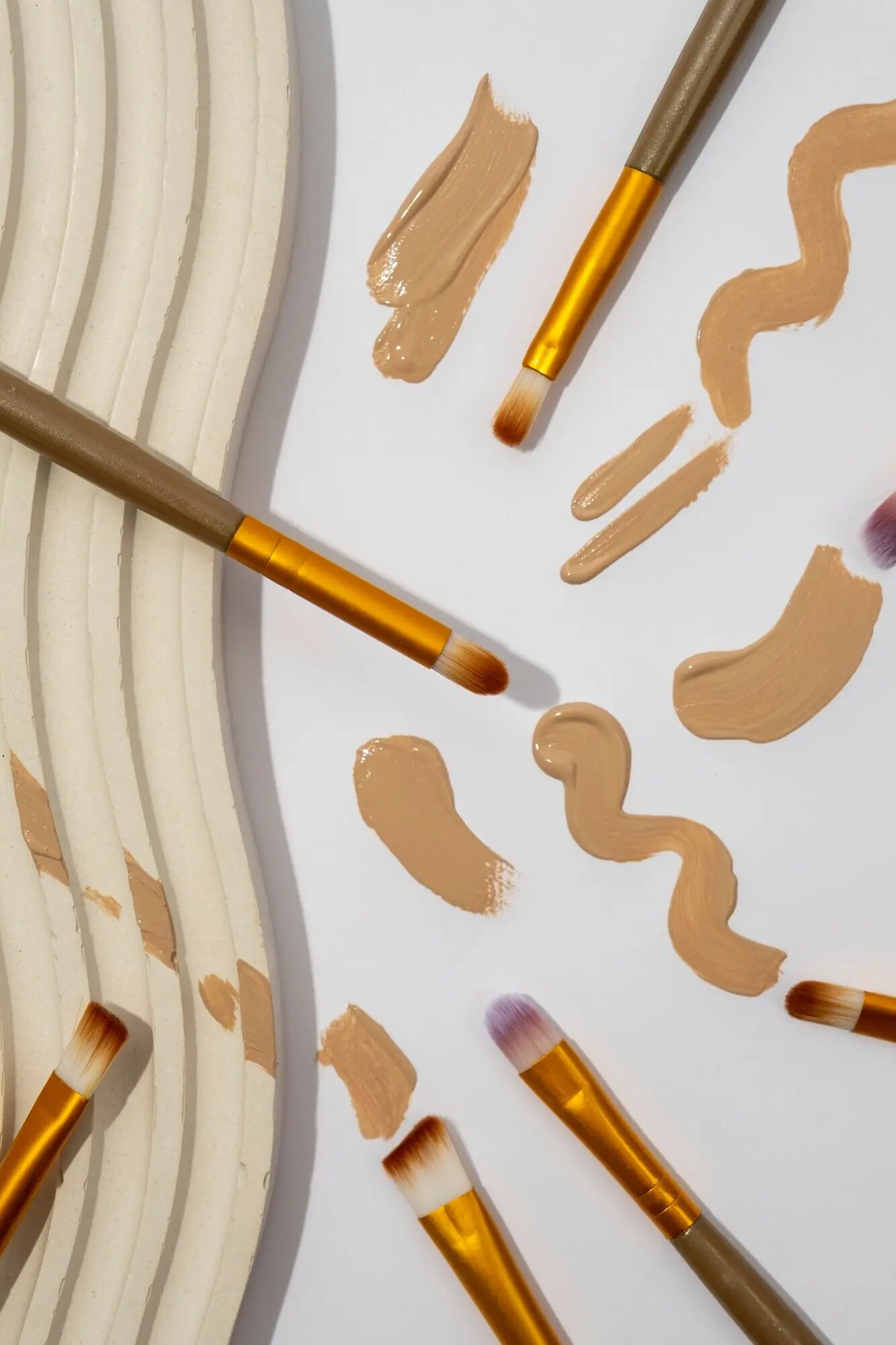 A look at a selection of brushes with brown paint.